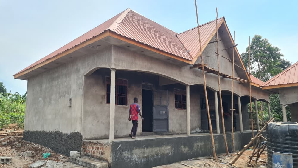 School building with a completed roof and unfinished exterior
