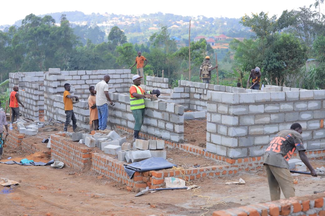 Construction team raising the classroom block walls