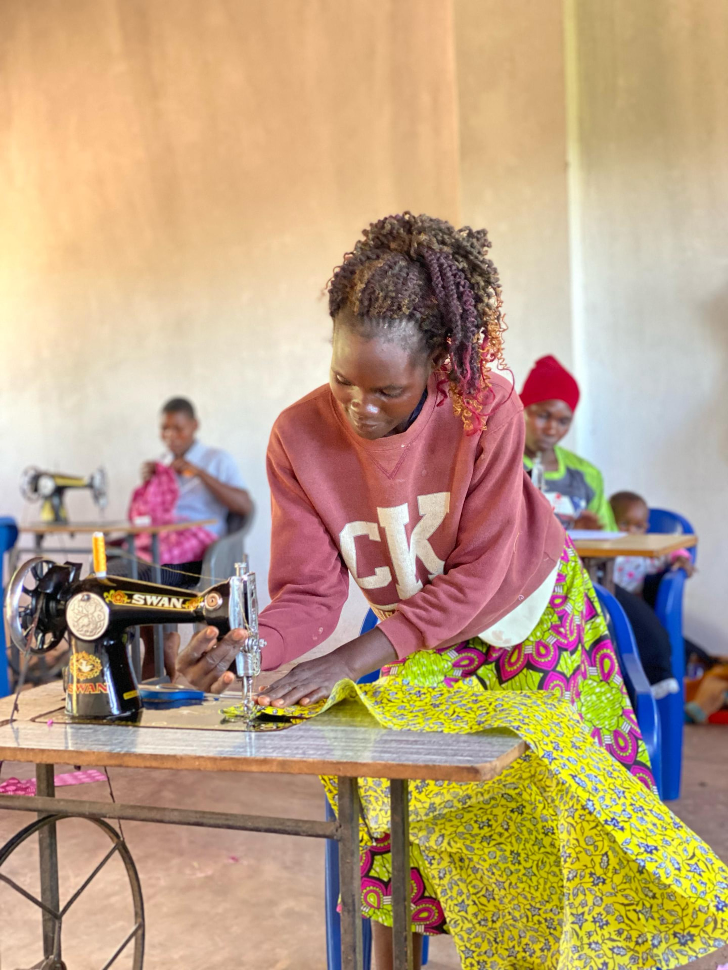 Mother practising on a treadle sewing machine